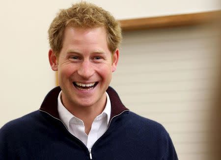 Britain's Prince Harry laughs as he meets locals at the Stewart Island community center during his visit to Stewart Island in the south of New Zealand, May 10, 2015. REUTERS/Dianne Manson/Pool