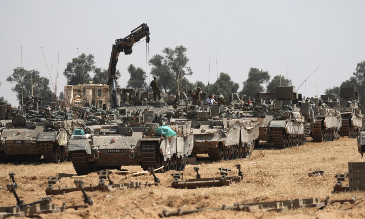<span>Israeli soldiers with military vehicles gathered at a position on the southern border with the Gaza Strip, near Rafah.</span><span>Photograph: Atef Safadi/EPA</span>