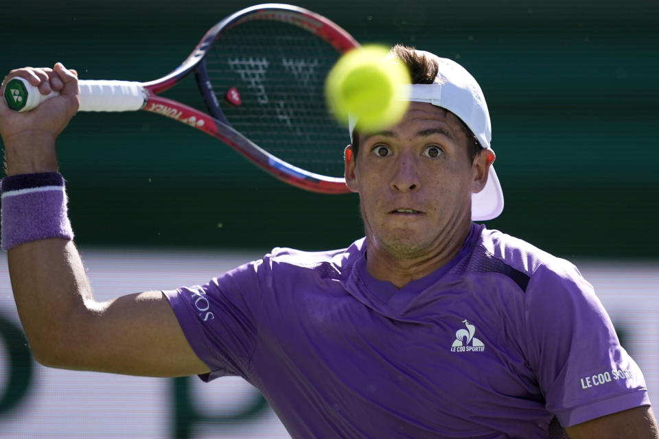 Sebastian Baez, of Argentina, returns a shot against Taylor Fritz, of the United States, at the BNP Paribas Open tennis tournament, Monday, March 11, 2024, in Indian Wells, Calif. (AP Photo/Mark J. Terrill)