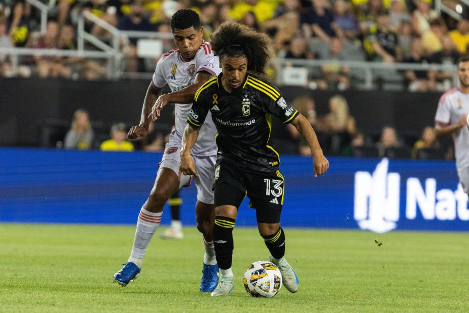 Sep 21, 2024; Columbus, Ohio, USA; Columbus Crew midfielder Aziel Jackson (13) dribbles the ball while Orlando City defender Rafael Santos (3) defends in the first half at Lower.com Field. Mandatory Credit: Trevor Ruszkowski-Imagn Images