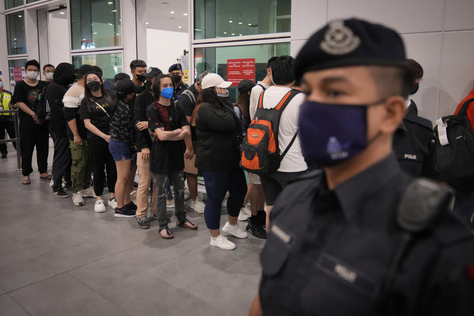 Malaysian youths rescued from human traffickers in Cambodia arrive at the Kuala Lumpur Airport Terminal in Sepang, Malaysia, Friday, Sept. 9, 2022. Foreign Minister Saifuddin Abdullah urged Malaysians to be wary of offers of lucrative jobs and free holidays, as he brought back the two dozen youths. (AP Photo/Vincent Thian)