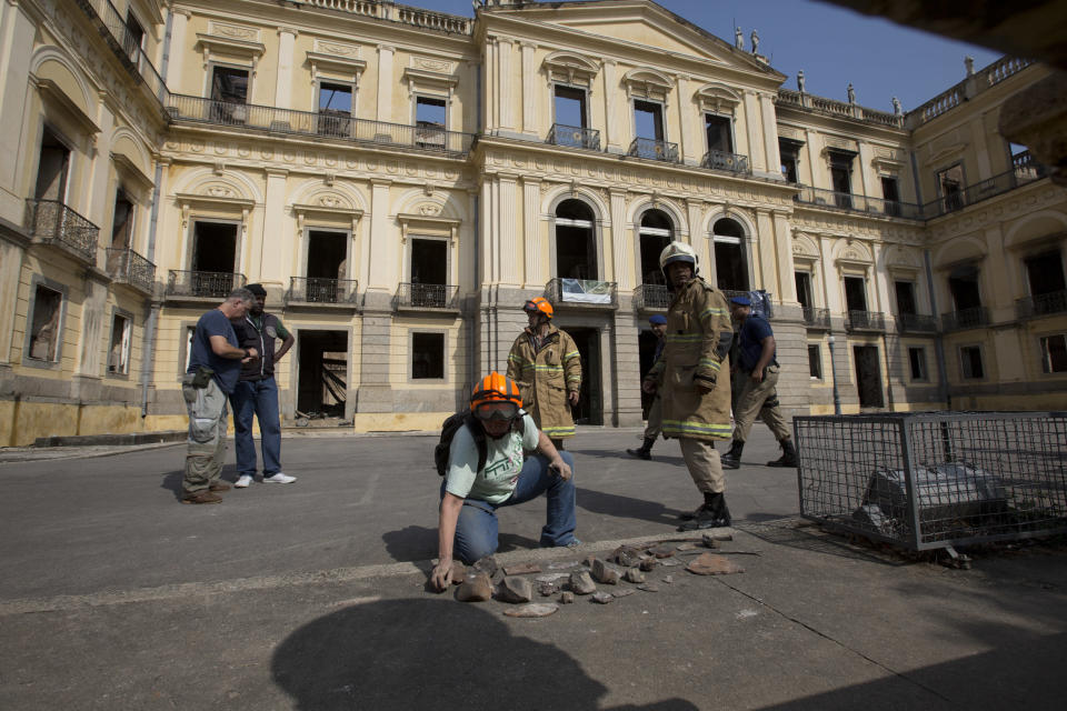 <p> A National Museum worker organizes pieces rescued from the museum after an overnight fire in Rio de Janeiro, Brazil, Monday, Sept. 3, 2018. A huge fire engulfed Brazil's 200-year-old National Museum in Rio de Janeiro, lighting up the night sky with towering flames as firefighters and museum workers raced to save historical relics from the blaze. (AP Photo/Silvia Izquierdo) </p>