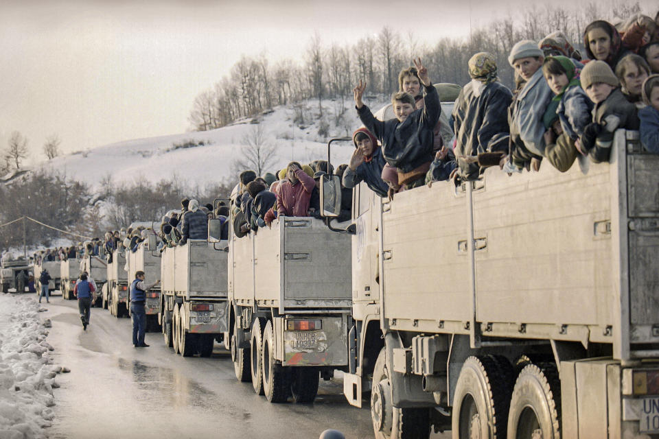 FILE- In this Monday, March 29, 1993 file picture, more than 2,000 evacuees from the besieged Muslim enclave of Srebrenica, packed on U.N. trucks en route to Tuzla, halt in Tojsici. The evacuation was possible due to a rare ceasefire in the area. Survivors of the genocide in the eastern Bosnian town of Srebrenica, mainly women, will on Saturday July 11, 2020, commemorate the 25th anniversary of the slaughter of their fathers and brothers, husbands and sons. At least 8,000 mostly Muslim men and boys were chased through woods in and around Srebrenica by Serb troops in what is considered the worst carnage of civilians in Europe since World War II. The slaughter was also the only atrocity of the brutal war that has been confirmed an act of genocide. (AP Photo/Michel Euler, File)