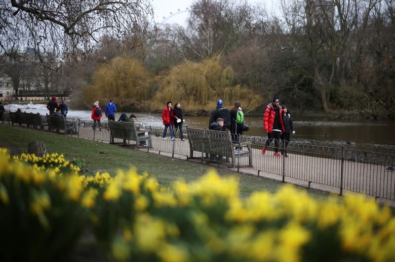 People walk past daffodils in St James's Park, amid the coronavirus disease (COVID-19) outbreak in London