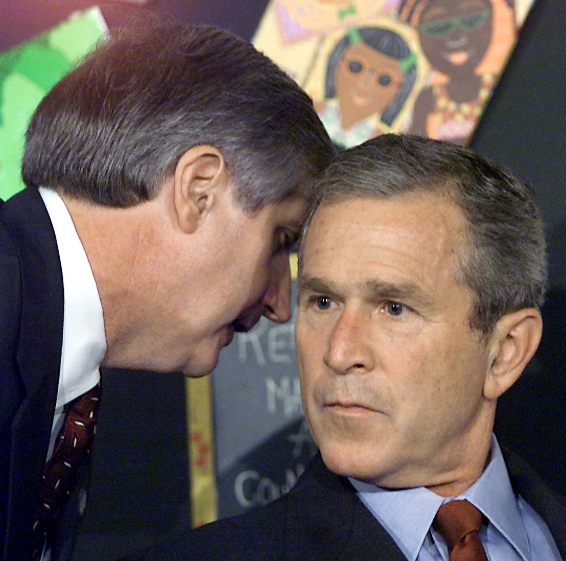 US President George W. Bush has his early morning school reading event interrupted by his Chief of Staff Andrew Card (L) shortly after news of the New York City airplane crashes was available in Sarasota, Florida.