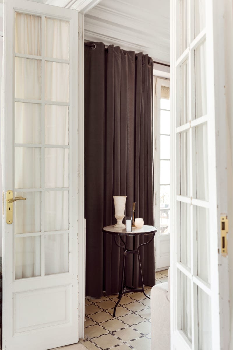 Accent table decorated at doorway with French doors.