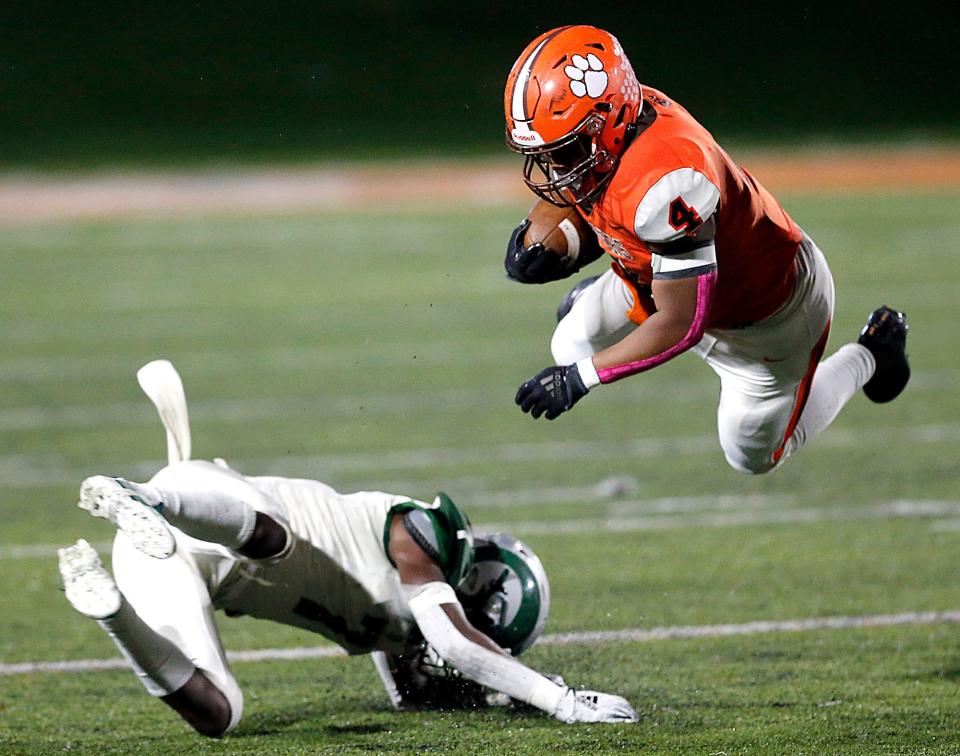 Madison High School's Kaleb Gordon (7) upends Mansfield Senior High School's Jamir Petty (4) during high school football action Friday, Oct. 20, 2023 at Arlin Field. TOM E. PUSKAR/MANSFIELD NEWS JOURNAL