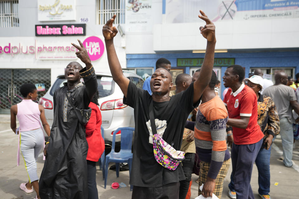 People celebrates after electoral officials announce a result from of the polling station in Lagos, Nigeria, Saturday, March 18, 2023. Millions of Nigerians are headed back to the polls Saturday as Africa's most populous nation holds gubernatorial elections amid tensions after last month's disputed presidential vote. New governors are being chosen for 28 of Nigeria's 36 states as the opposition continues to reject the victory of President-elect Bola Tinubu from the West African nation's ruling party. (AP Photo/Sunday Alamba)