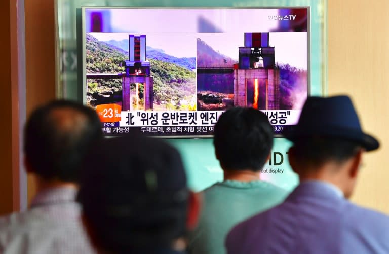 People watch a television news report about North Korea's latest ground test for a rocket engine, at a railway station in Seoul on September 20, 2016