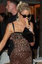 <p>Khloé Kardashian goes full Italian bombshell with slinky dress complete with leopard print bustier top, a tiny bag and statement cross earrings (sensing a jewellery theme across the family here). </p>