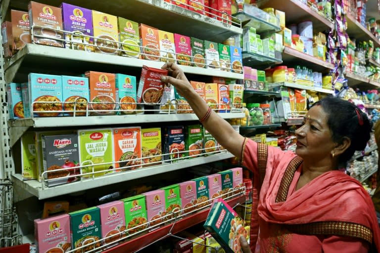 A woman buys spice packets at a store in the Indian city of Amritsar on May 21 (Narinder NANU)