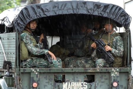 Philippine soldiers ride on a military vehicle while government forces continue their assault against insurgents from the Maute group, in Marawi, Philippines June 26, 2017. REUTERS/Jorge Silva