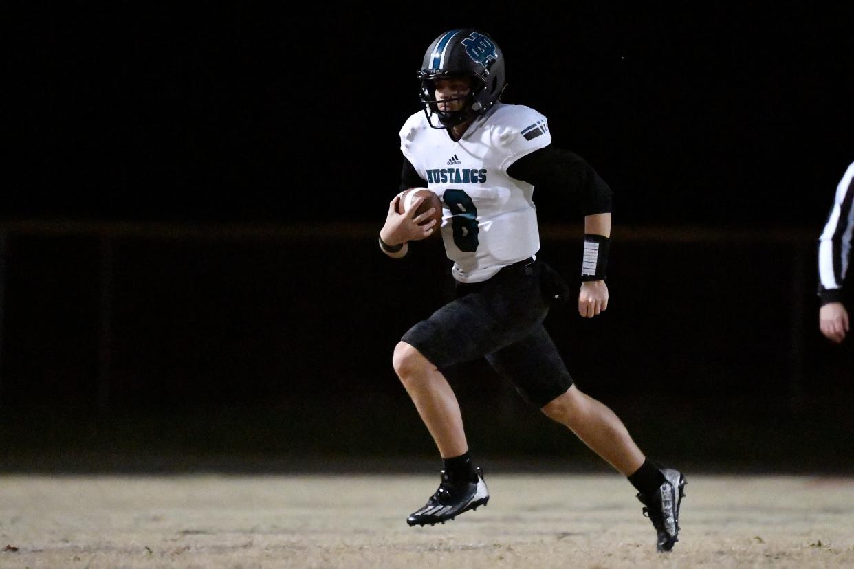 North Oldham quarterback Jace Bullock runs for yardage against Jeffersontown in November. Bullock recently committed to Eastern Kentucky.