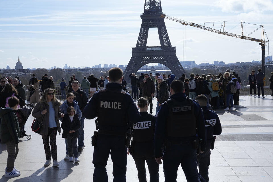 Police officers patrol on the Trocadero square Monday, March 25, 2024 in Paris. France's government increased its security alert posture to the highest level Sunday March 24, 2024 after the deadly attack at a Russian concert hall and the Islamic State's claim of responsibility. (AP Photo/Michel Euler)