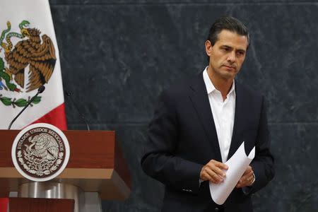 Mexico's President Enrique Pena Nieto looks on after addressing the media about a private meeting with the relatives of the 43 missing students of Ayotzinapa Teacher Training College Raul Isidro Burgos, at Los Pinos presidential residence in Mexico City in this October 29, 2014 file photo. Mexican President Enrique Pena Nieto misrepresented to authorities the circumstances under which he acquired one of his properties, public documents reviewed by Reuters show, a discrepancy that could add to the controversy surrounding his personal finances. REUTERS/Bernardo Montoya/Files