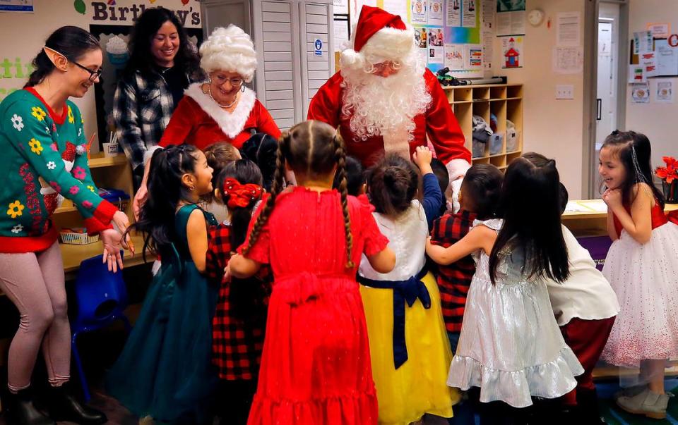 Santa and Mrs. Claus receive an enthusiastic greeting from students at the Sunset Ridge Benton Franklin Head Start in Pasco. Santa was Bob Schuetz, Energy Northwest CEO, and his wife, Brenda, is Mrs. Claus. Head Start employee Jessica Stone joins the party as a workshop elf.