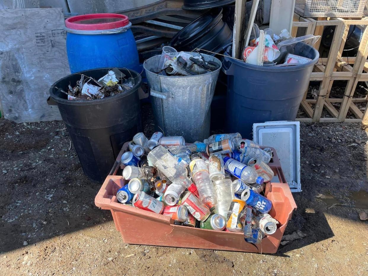 Dave and Lisa Doucette cleaned up three large garbage cans of trash and a bin full of alcohol containers near Highway 101 last week.  (Dave Lisa Doucette/Facebook - image credit)