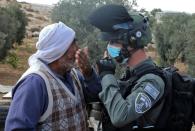Protestors confront Israeli forces as a structure serving as a home to a Palestinian family is demolished in the southern West Bank on August 11