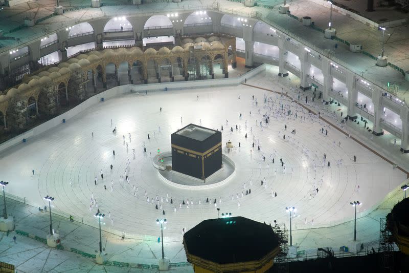 The first group of Muslims, allowed in the mosque compound by appointment, practice social distancing, as they perform Umrah in the Grand Mosque, after Saudi authorities ease coronavirus disease (COVID-19) restrictions, in the holy city of Mecca