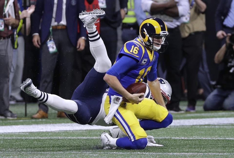 Los Angeles Rams' Jared Goff (16) gets sacked by New England Patriots' Kyle Van Noy, rear, during the first half of the NFL Super Bowl 53 football game Sunday, Feb. 3, 2019, in Atlanta. (AP Photo/David J. Phillip)