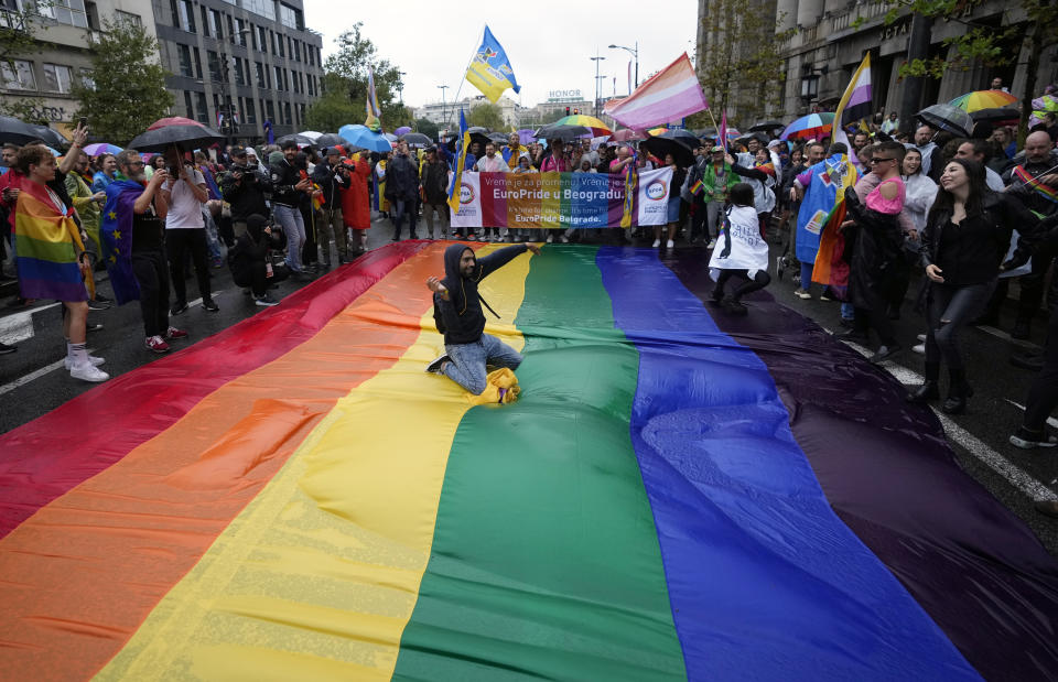 Participants take part in the European LGBTQ pride march in Belgrade, Serbia, Saturday, Sept. 17, 2022. Serbian police have banned Saturday's parade, citing a risk of clashes with far-right activists. (AP Photo/Darko Vojinovic)