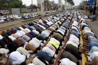 Supporters of Tehreek-e-Labiak Pakistan, a radical Islamist political party, perform Friday prayer during a sit-in protest against the arrest of their party leader Saad Rizvi and demanding to expel the French envoy from the country, in Lahore, Pakistan, Friday, April 16, 2021. Pakistan briefly blocked access to all social media on Friday, after days of anti-French protests across the country by radical Islamists opposed to cartoons they consider blasphemous. (AP Photo/K.M. Chaudary)