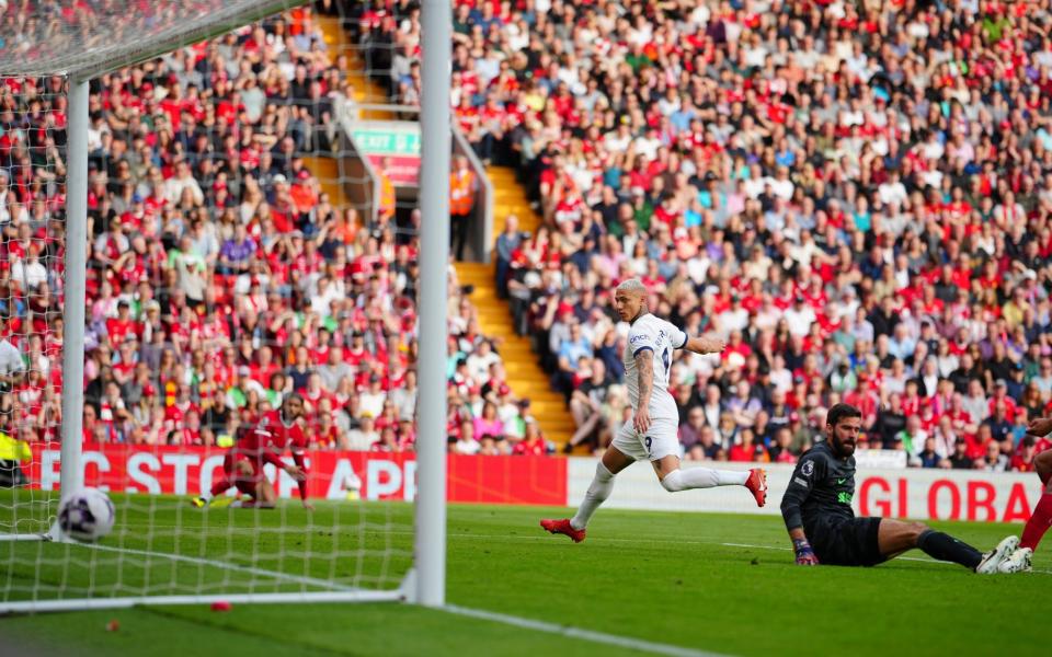 Tottenham's Richarlison, center, scores his side's first goal during the English Premier League soccer match