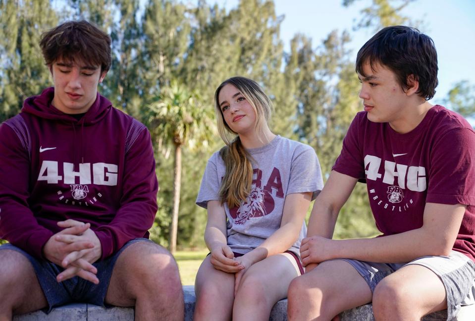 From left: Christian, Hailee and Jonathan Moder sit outside during First Baptist Academy's practice at Coach Mike DiGrigoli's house in Naples on Tuesday, Feb. 14, 2023.
