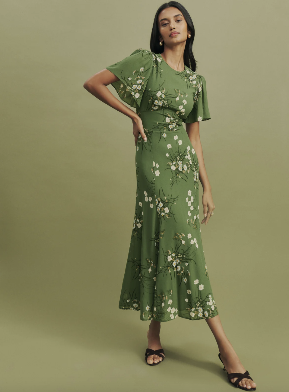 model wearing green floral Roxana Dress (photo via Reformation)