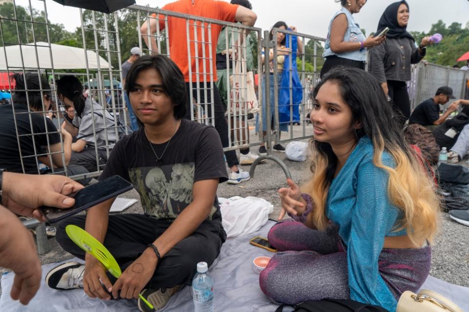  Azam and his group of nine friends have been waiting in line at the Standing Zone since midnight. — Picture by Shafwan Zaidon. 