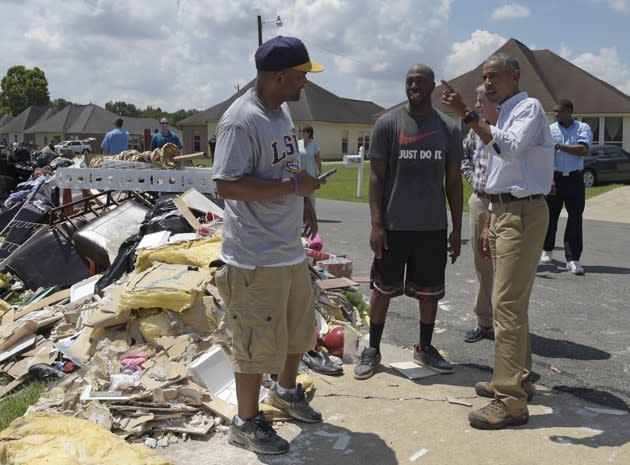 President Obama talks with Quincy ‎Snowden as he tours Castle Place, a flood-damaged area of Baton Rouge, Louisiana, on Tuesday. Susan Walsh / AP
