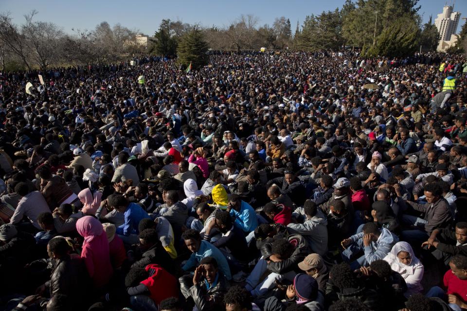 African migrants protest outside Israel’s parliament in Jerusalem, Wednesday, Jan. 8, 2014. Thousands of African migrants demanded to be recognized as refugees in a protest Wednesday outside of Israel’s parliament, part of a series of events showing the migrants’ growing frustration with their fate in Israel. Police said more than 10,000 migrants rallied outside the Knesset, with hundreds more continuing to stream in to Jerusalem from around the country. The migrants have staged two other mass protests in Tel Aviv where they have demanded the right to work and better treatment from the Israeli government. (AP Photo/Ariel Schalit)