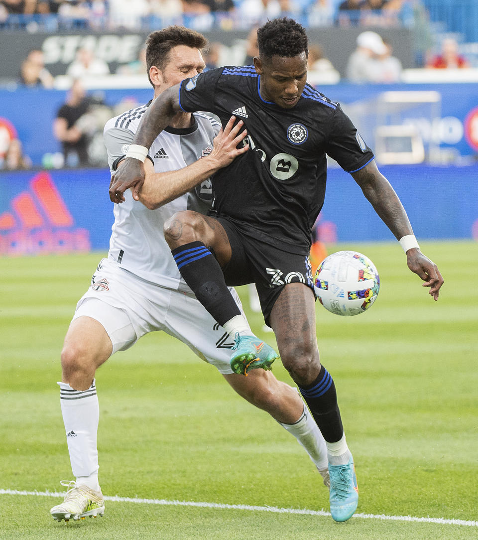 CF Montreal's Romell Quioto, right, is challenged by Toronto FC's Shane O'Neill during the first half of an MLS soccer match Saturday, July 16, 2022, in Montreal. (Graham Hughes/The Canadian Press via AP)