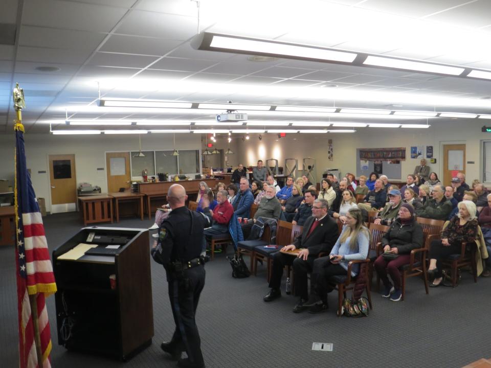 Police Sgt. Chris Somjen makes a presentation on auto theft statistics during a town hall at Mountain Lakes high School with Morris County Prosecutor Robert Carroll.