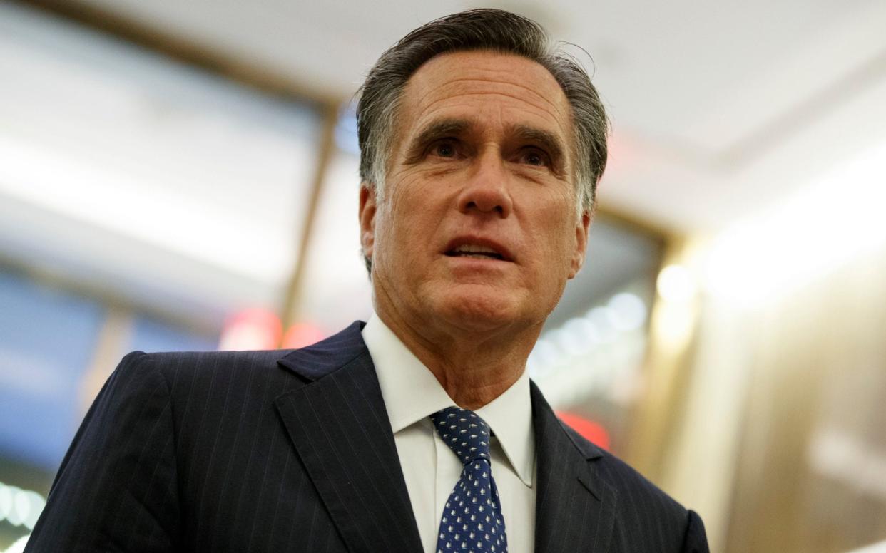 Mitt Romney, the Utah senator, talks with reporters - AP