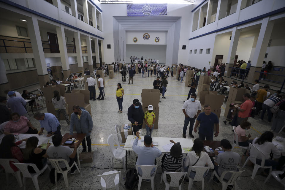 Voters line up at a poling station during a presidential runoff in Bucaramanga, Colombia, Sunday, June 19, 2022. (AP Photo/Ivan Valencia)