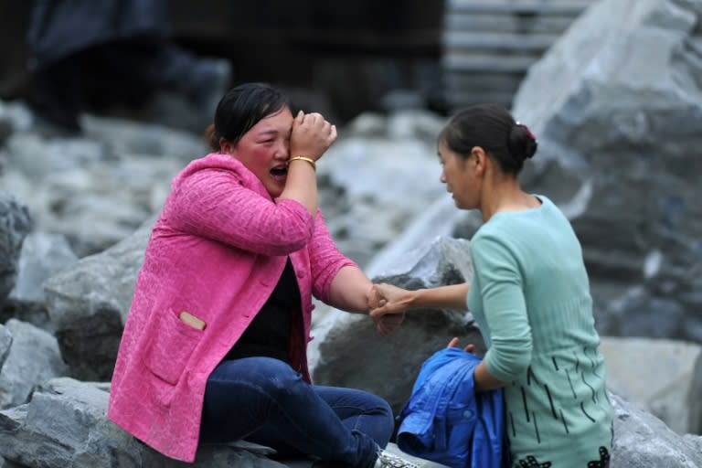 The number of people missing from a huge landslide that buried a mountain village in southwest China last weekend has been revised down from 93 to 73