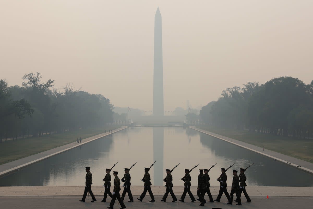 Members of the US Marine Corps rehearse in hazy smoke for the Sunset Parade at the Lincoln Memorial on June 8, 2023 in Washington, DC (Getty Images)