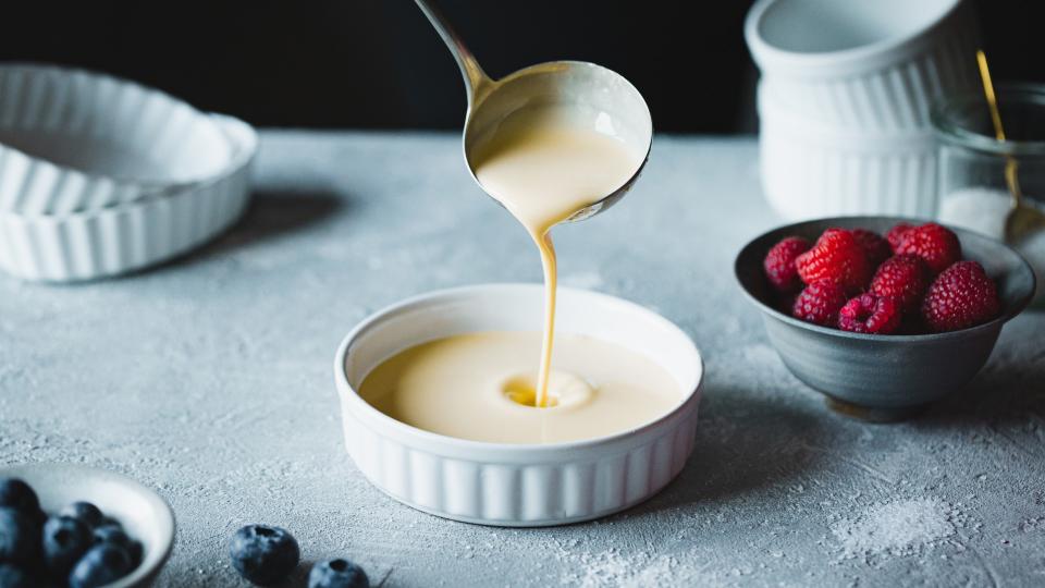 Bowl of custard with various fruits on the table