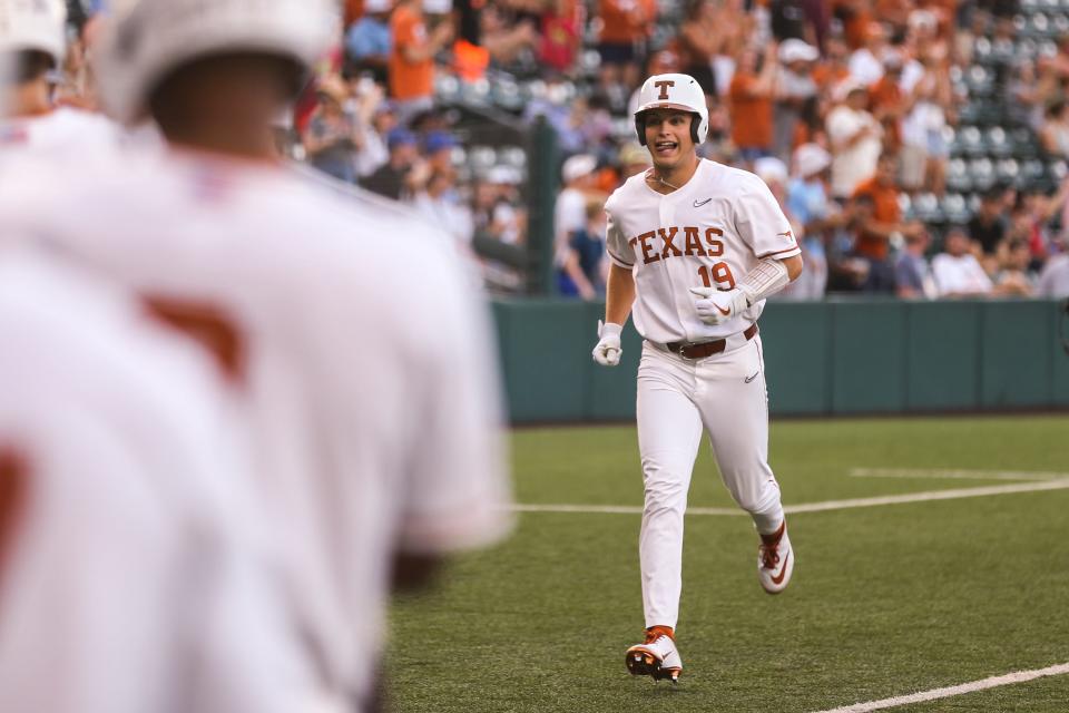 Texas' Mitchell Daly heads toward the plate after bashing a grand slam in Thursday night's 12-4 win over Kansas. The Longhorns have hit 100 homers this season, shattering the previous school record of 81. "I wouldn't say everybody's trying to hit a bomb," Daly said. "But when you work (hard in batting practice) like that every day, you know you're going to have good results that come with it."
