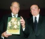 Former FIFA President Joao Havelange (L) holds up the autobiography written by head of the South American Soccer Confederation, Nicolas Leoz (R), during a ceremony in which Leoz presented his book in Asuncion, Paraguay, July 3, 2001. REUTERS/File photo