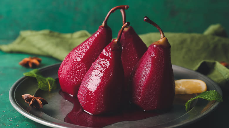 Four poached pears on plate