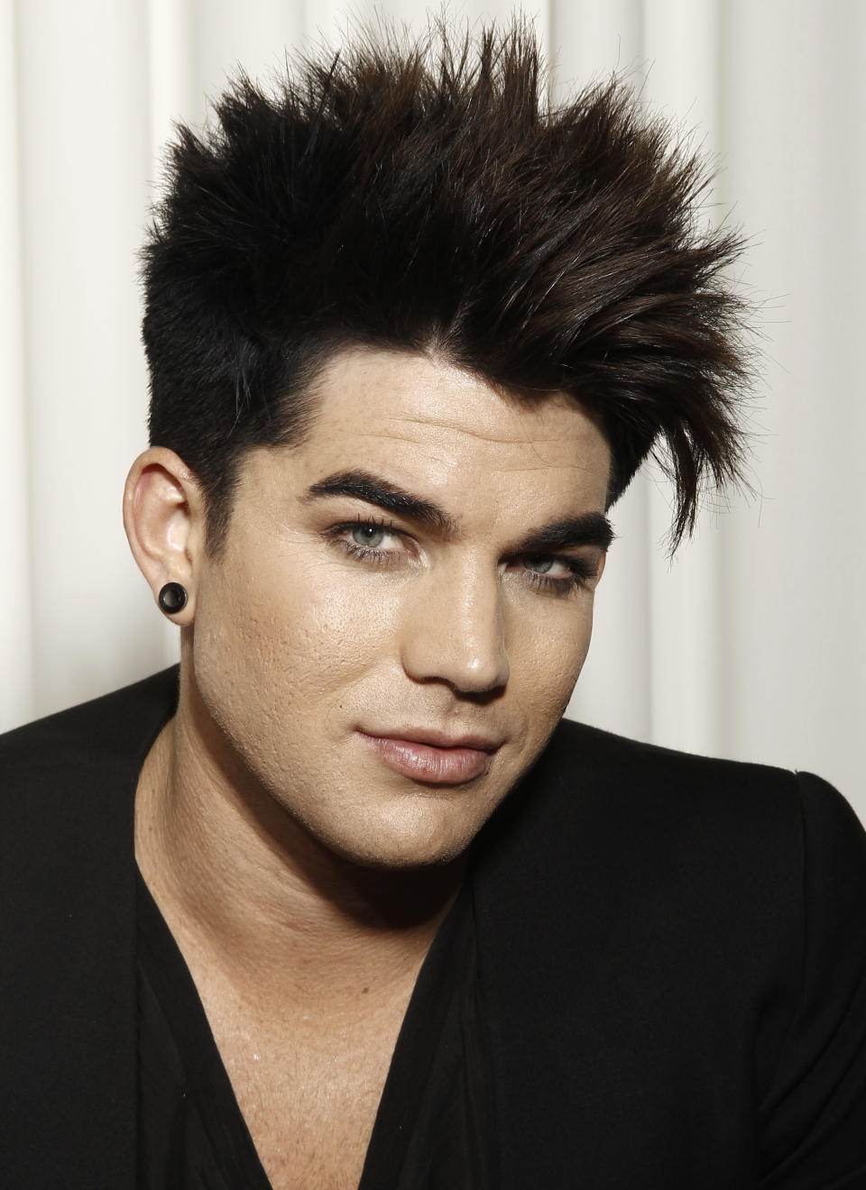 FILE - In this Jan. 23, 2012 file photo, musician Adam Lambert poses for a portrait in Beverly Hills, Calif. Lambert will host and perform at the “VH1 Divas” event on Dec. 16, in New York. Miley Cyrus, Demi Lovato, Kelly Rowland, Jordin Sparks and Ciara will also hit the stage at the special honoring dance music and its current and classic divas. Tributes to Whitney Houston and Donna Summer are also planned. (AP Photo/Matt Sayles, file)