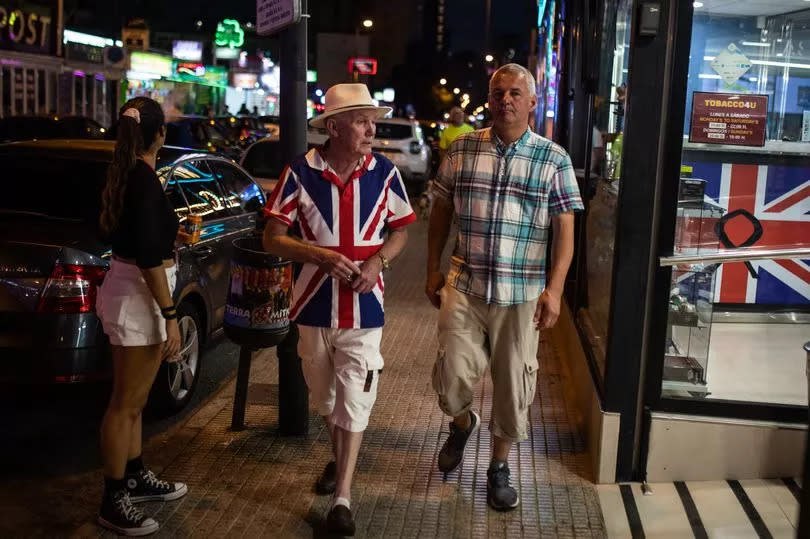 A tourist wearing a UK flag T-shirt strolls around in Benidorm, Spain