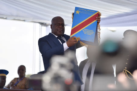 FILE PHOTO: Felix Tshisekedi holds up the constitution during his presidential the inauguration ceremony in Kinshasa, Democratic Republic of Congo, January 24, 2019. REUTERS/Olivia Acland/File Photo
