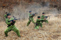 <p>North Korean soldiers with weapons attend military training in an undisclosed location in this picture released by the North’s official KCNA news agency in Pyongyang, North Korea, March 11, 2013. (KCNA/Reuters) </p>