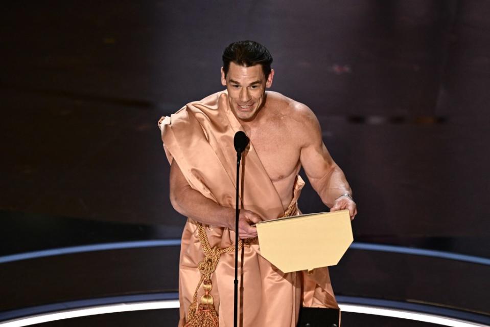 Cena managed to acquire a toga so that he could eventually present the award. Patrick T. Fallon / AFP