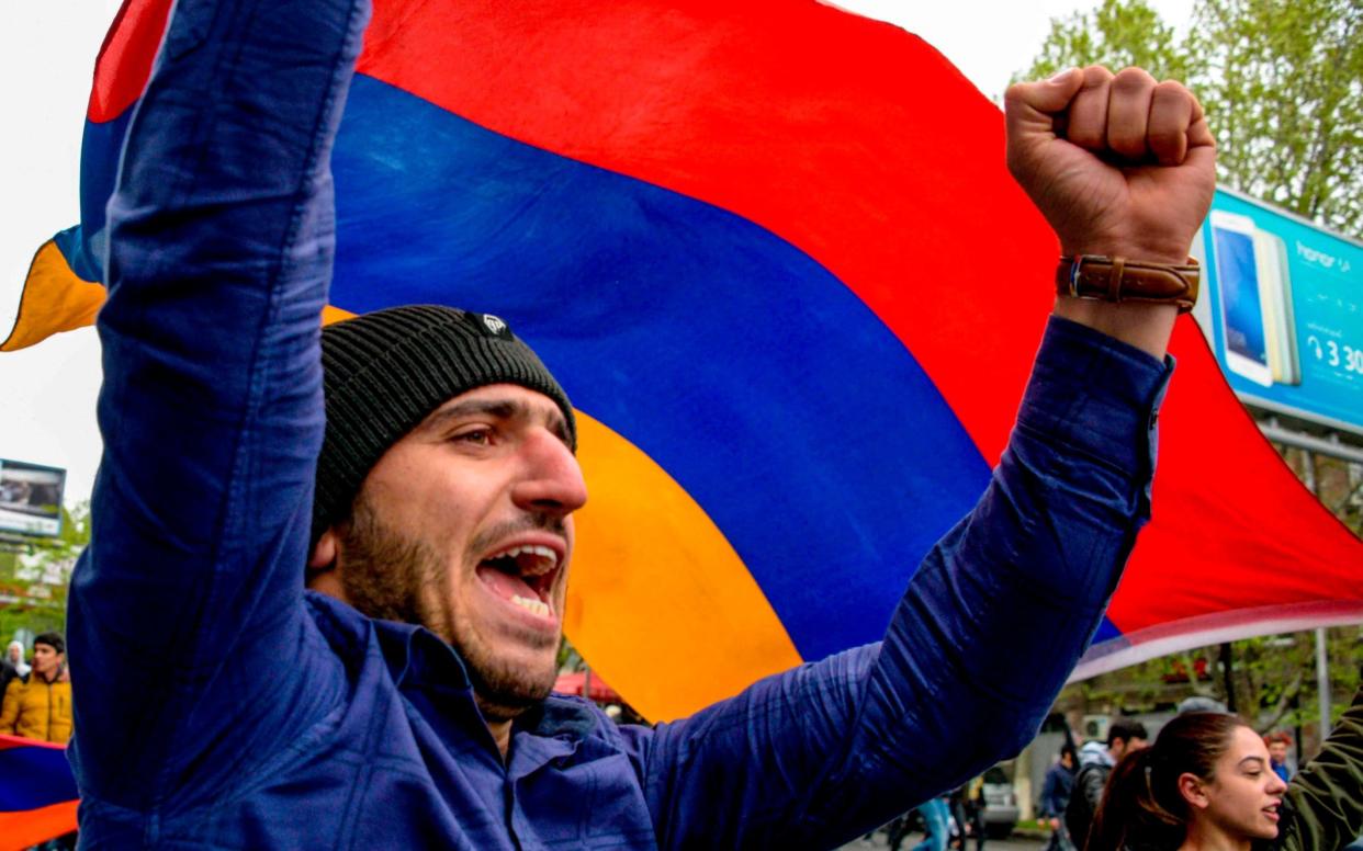 Armenian opposition supporter shouts during a rally in central Yerevan  - AFP