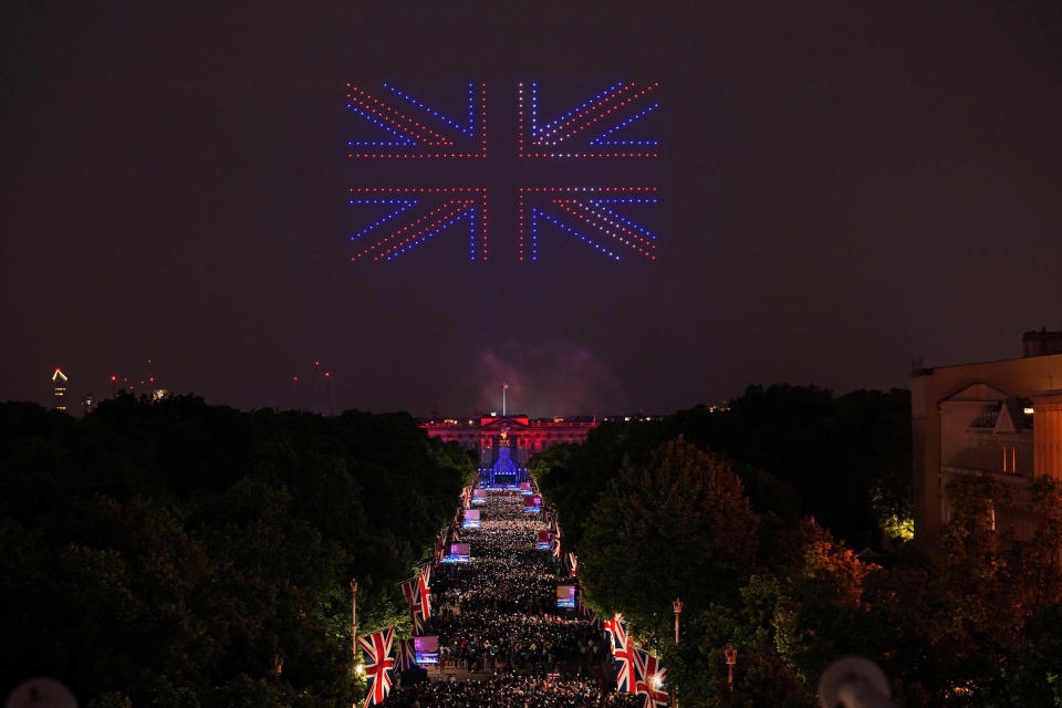 Drones make the shape of the Union flag above the Platinum Jubilee concert taking place in front of Buckingham Palace, London, Saturday June 4, 2022, on the third of four days of celebrations to mark the Platinum Jubilee. The events over a long holiday weekend in the U.K. are meant to celebrate Queen Elizabeth II's 70 years of service. (Dominic Lipinski/PA via AP)