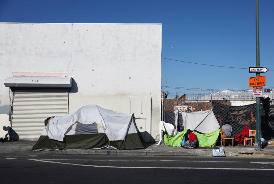People gather at a homeless encampment in the Skid Row area of Los Angeles in September 2023. (Photo by Mario Tama/Getty Images)